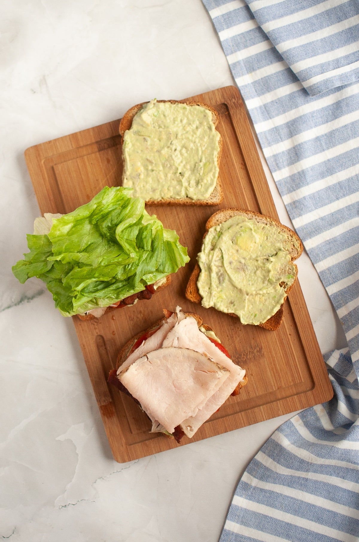 Turkey and lettuce are added to the turkey BLT sandwiches. 