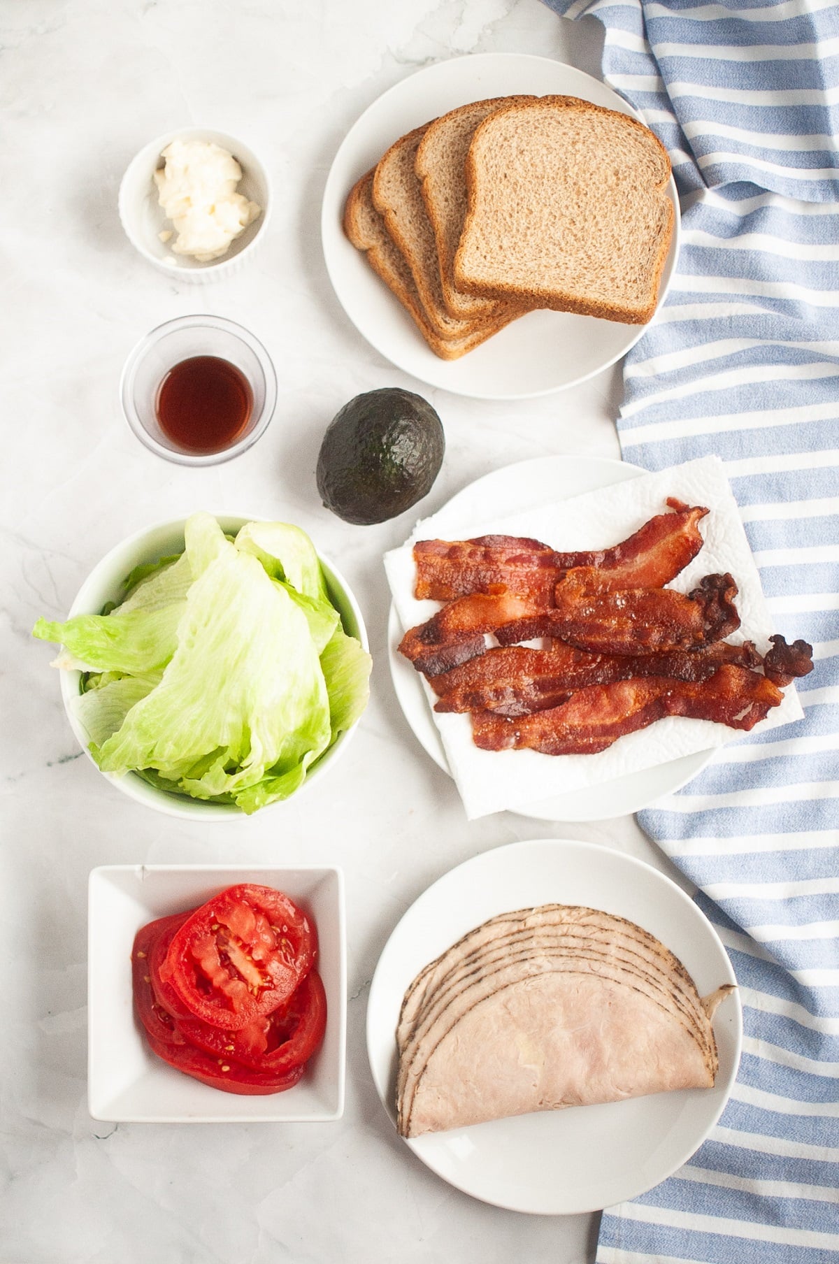 Ingredients for making a BLT with Turkey and avocado mayo. 