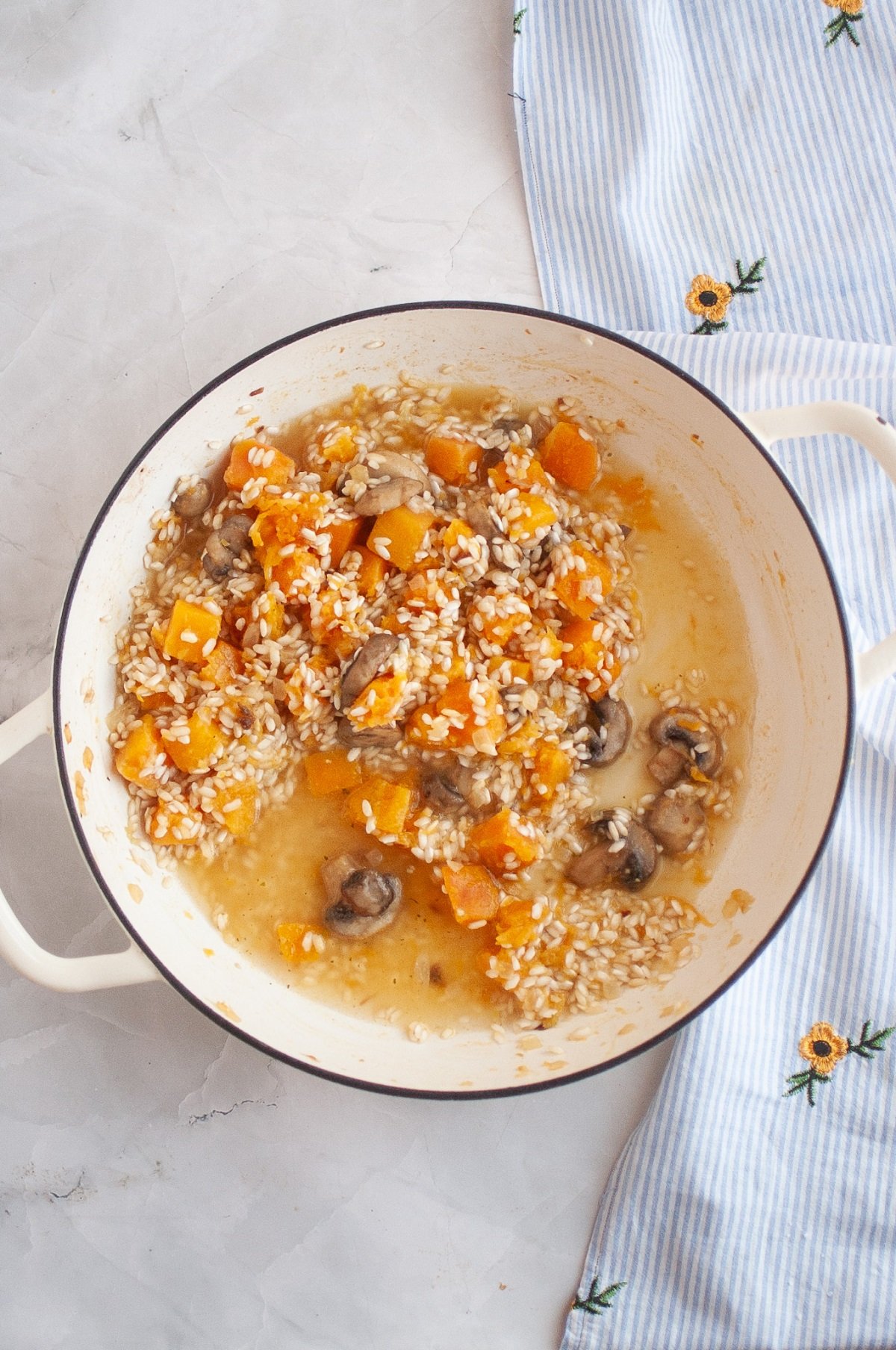 Broth is slowly added to rice as it cooks. 