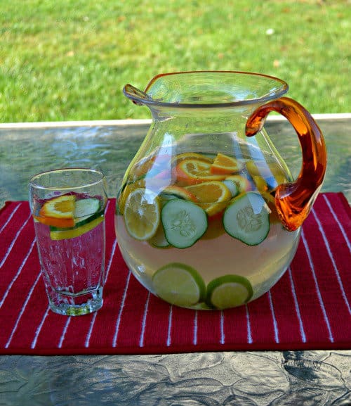 a pitcher and glass of citrus cucumber water