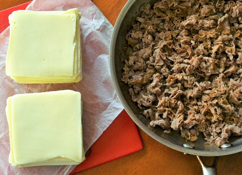 deli American next to a pan with cooked steak