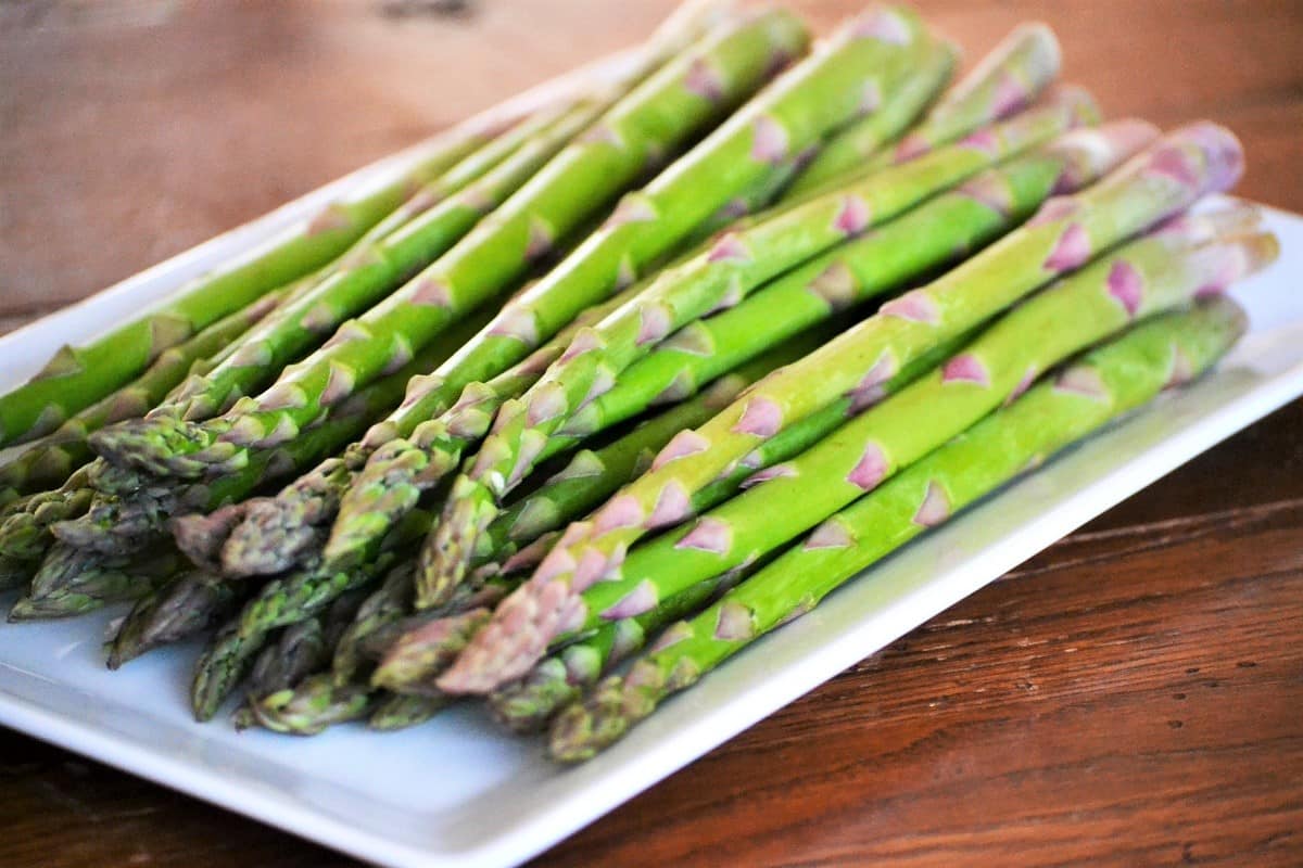 Fresh asparagus spears on a platter.
