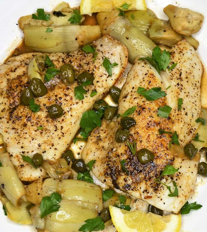 Fish with artichokes and capers on a plate