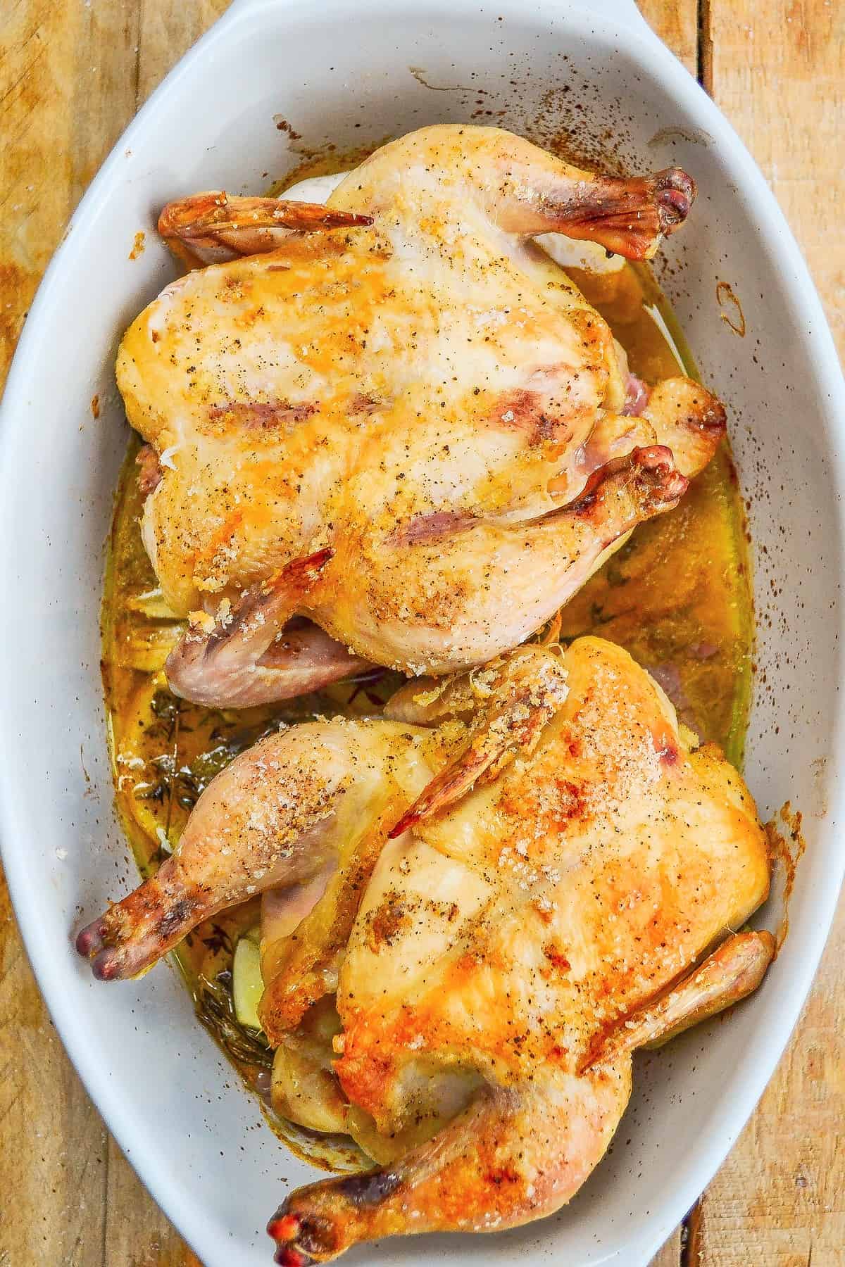 Roasted cornish game hens in a baking dish. 