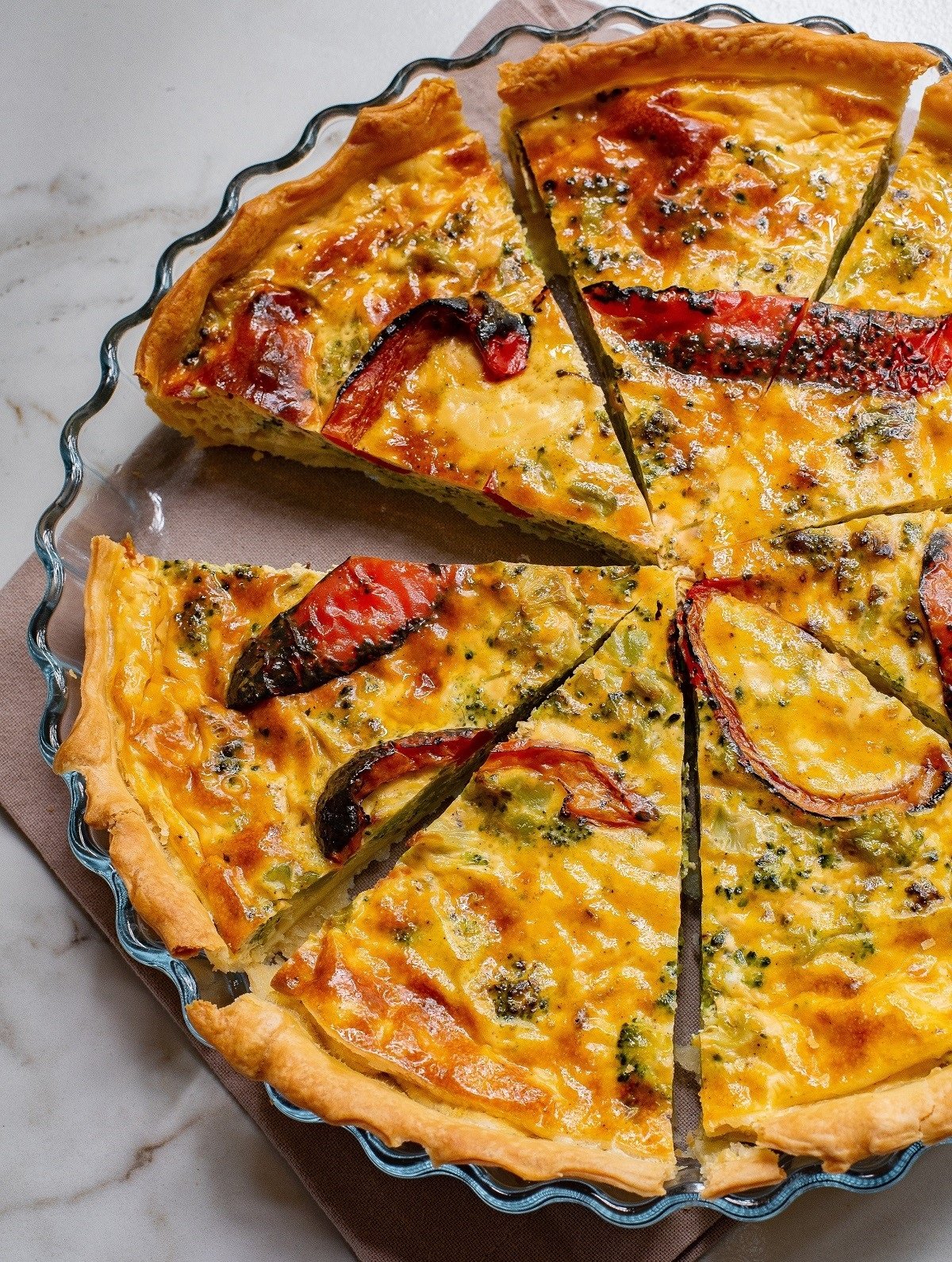 Sliced quiche with roasted red peppers.
