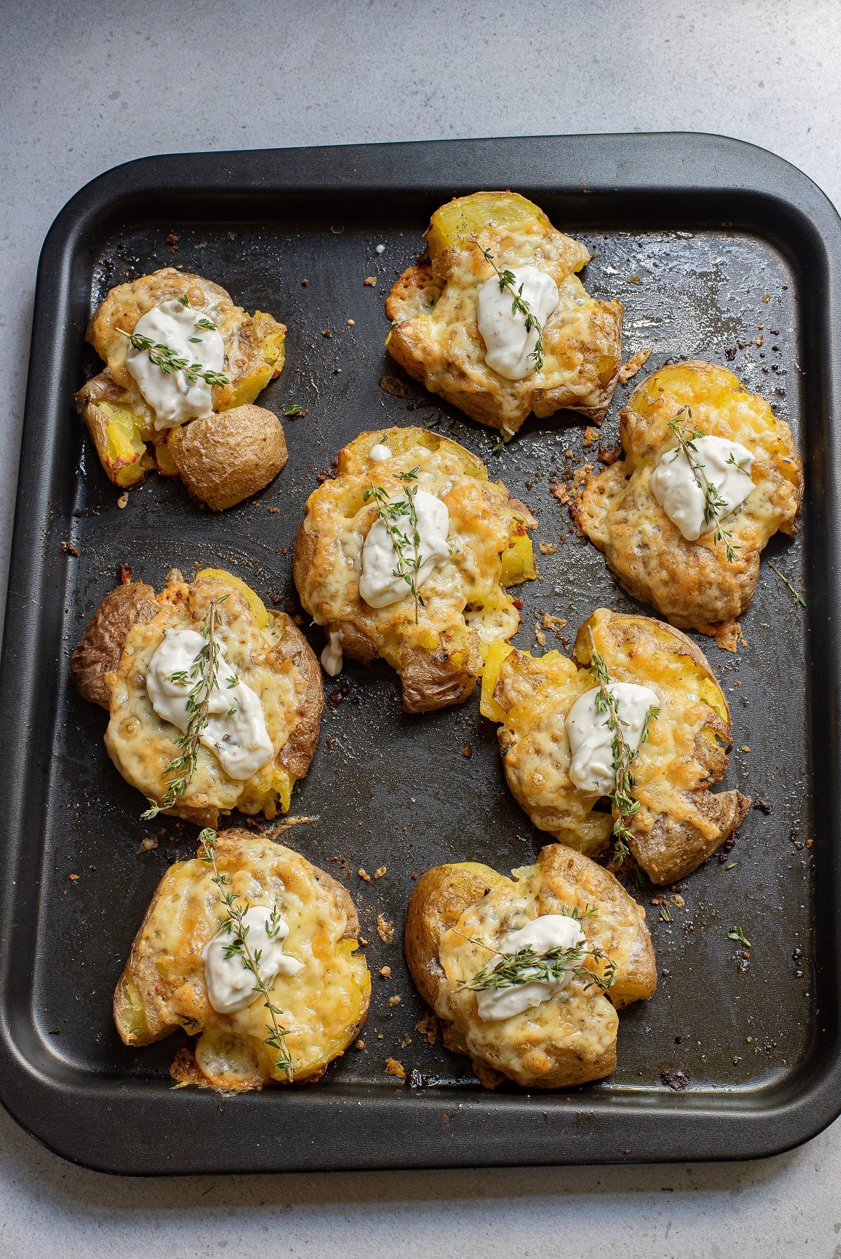 Garnish potatoes with sour cream and herbs before serving. 