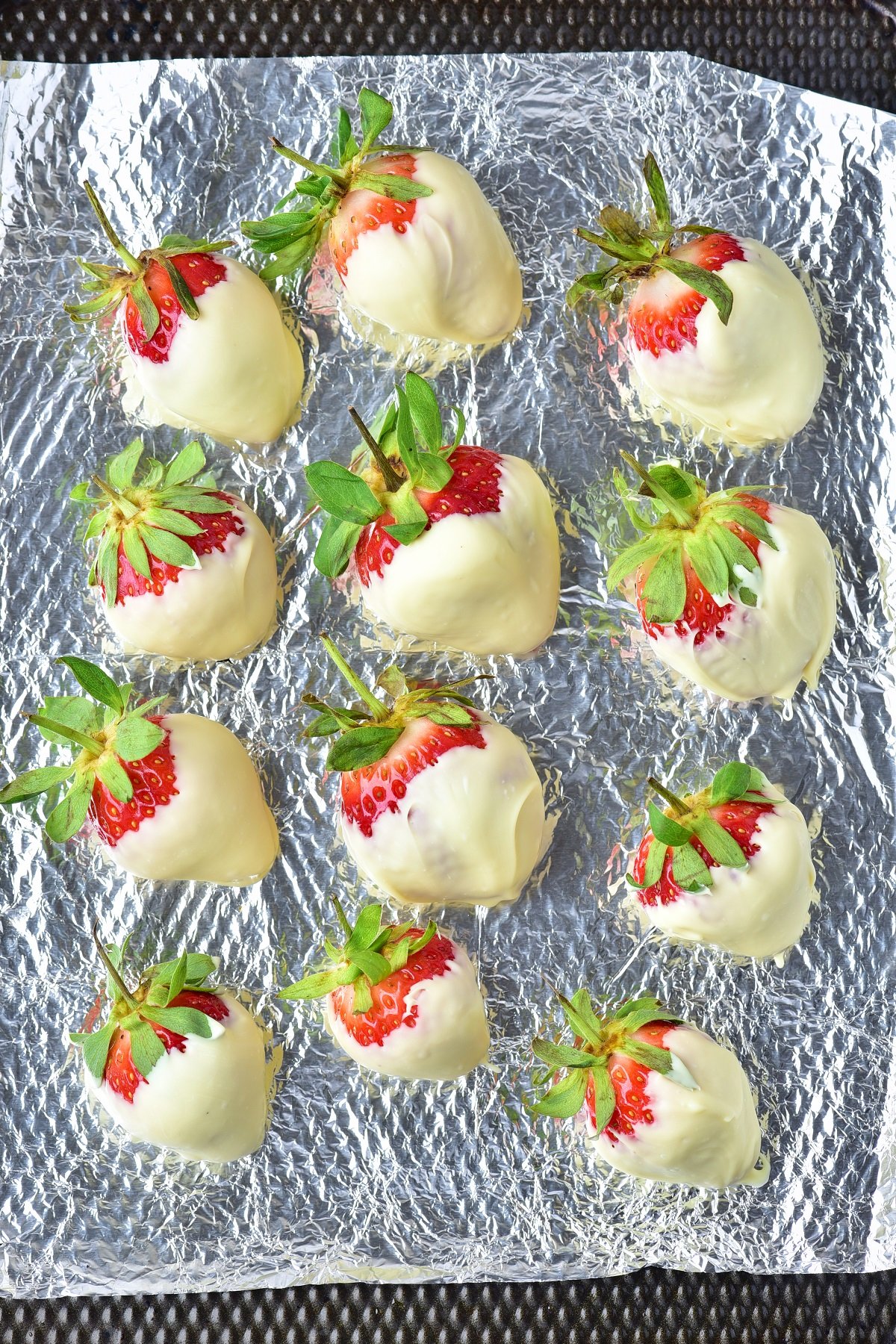 Fresh strawberries are dipped in white chocolate. 