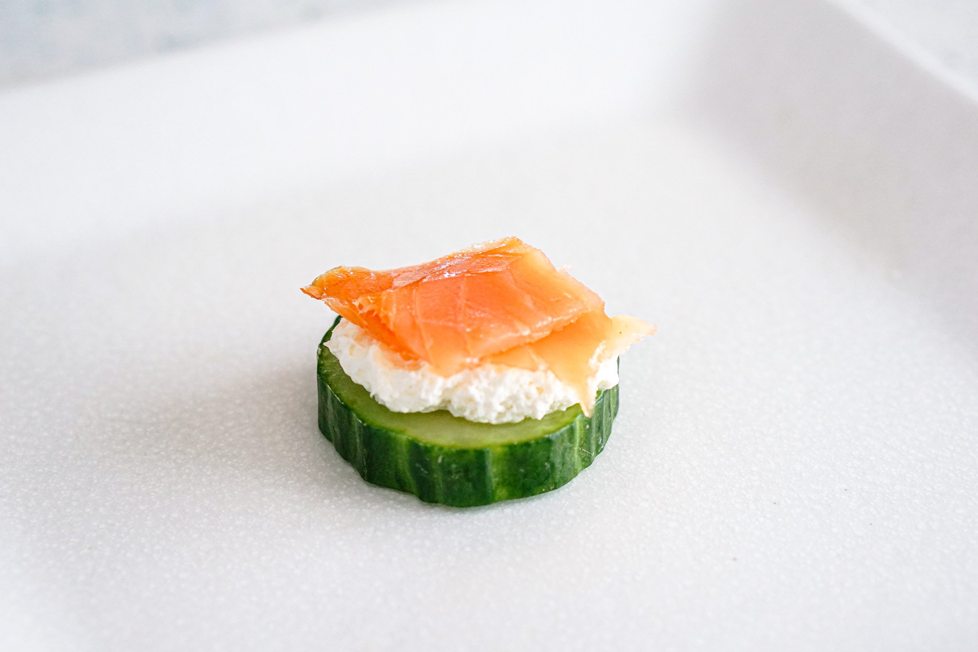 Top cream cheese with smoked salmon. 