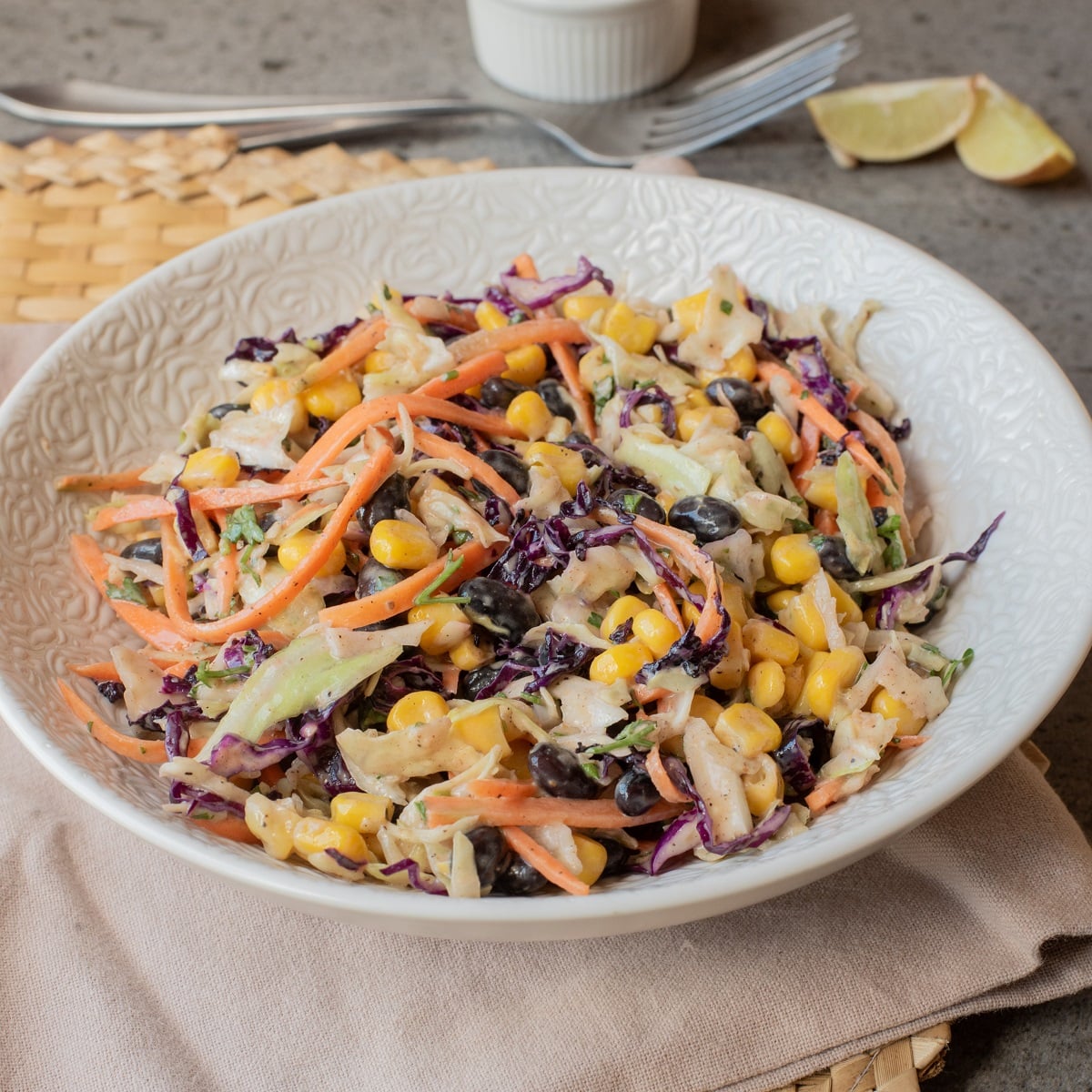 Southwest slaw on a plate with a fork beside the plate. 
