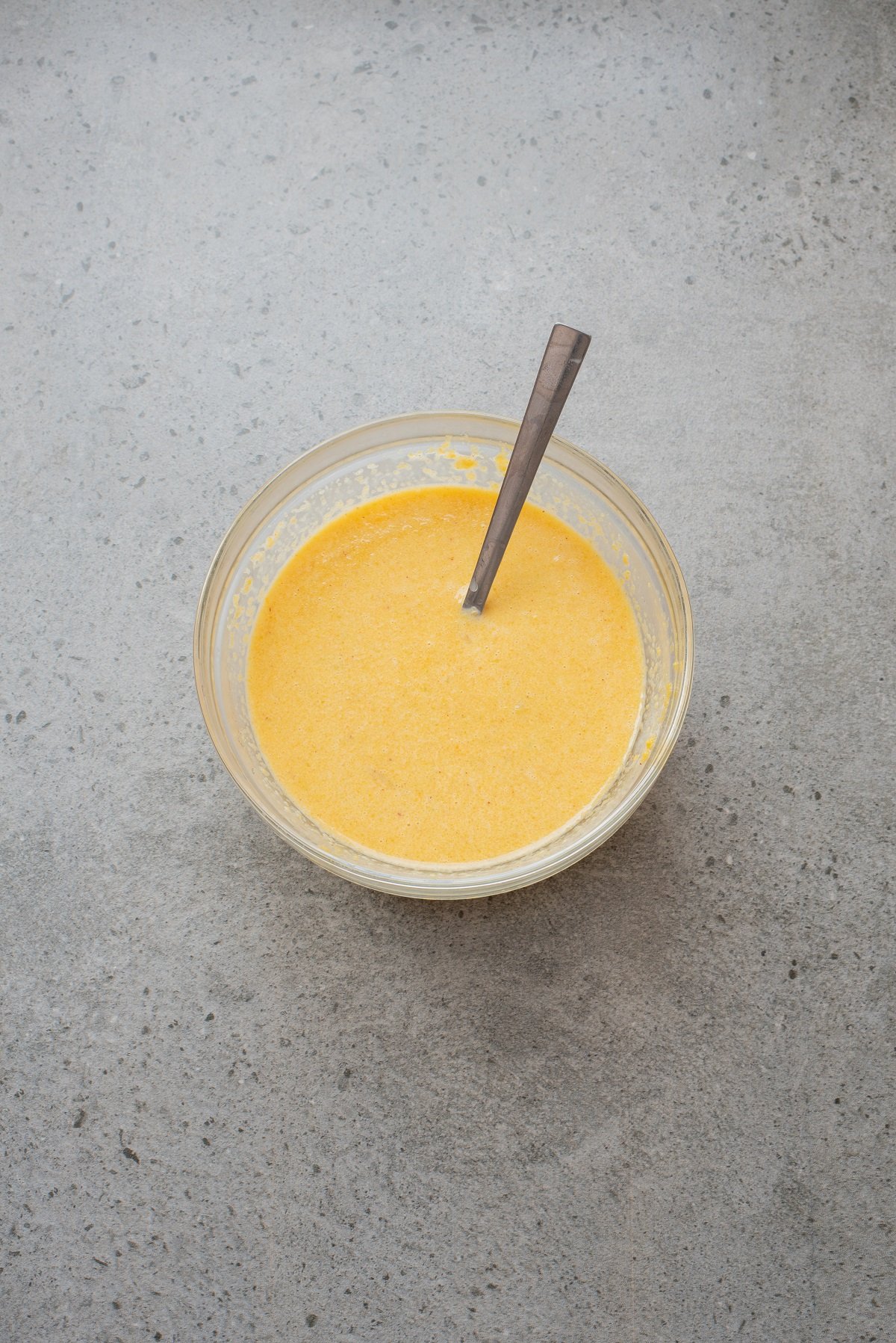 Pumpkin and egg are mixed together in a bowl. 