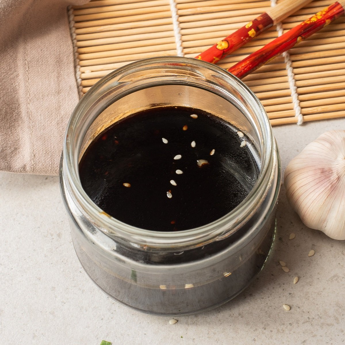 The cooled sauce is stored in a glass jar. 