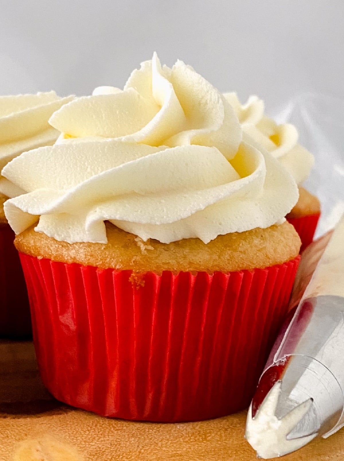 Closeup of a cupcake topped with fluffy buttercream.