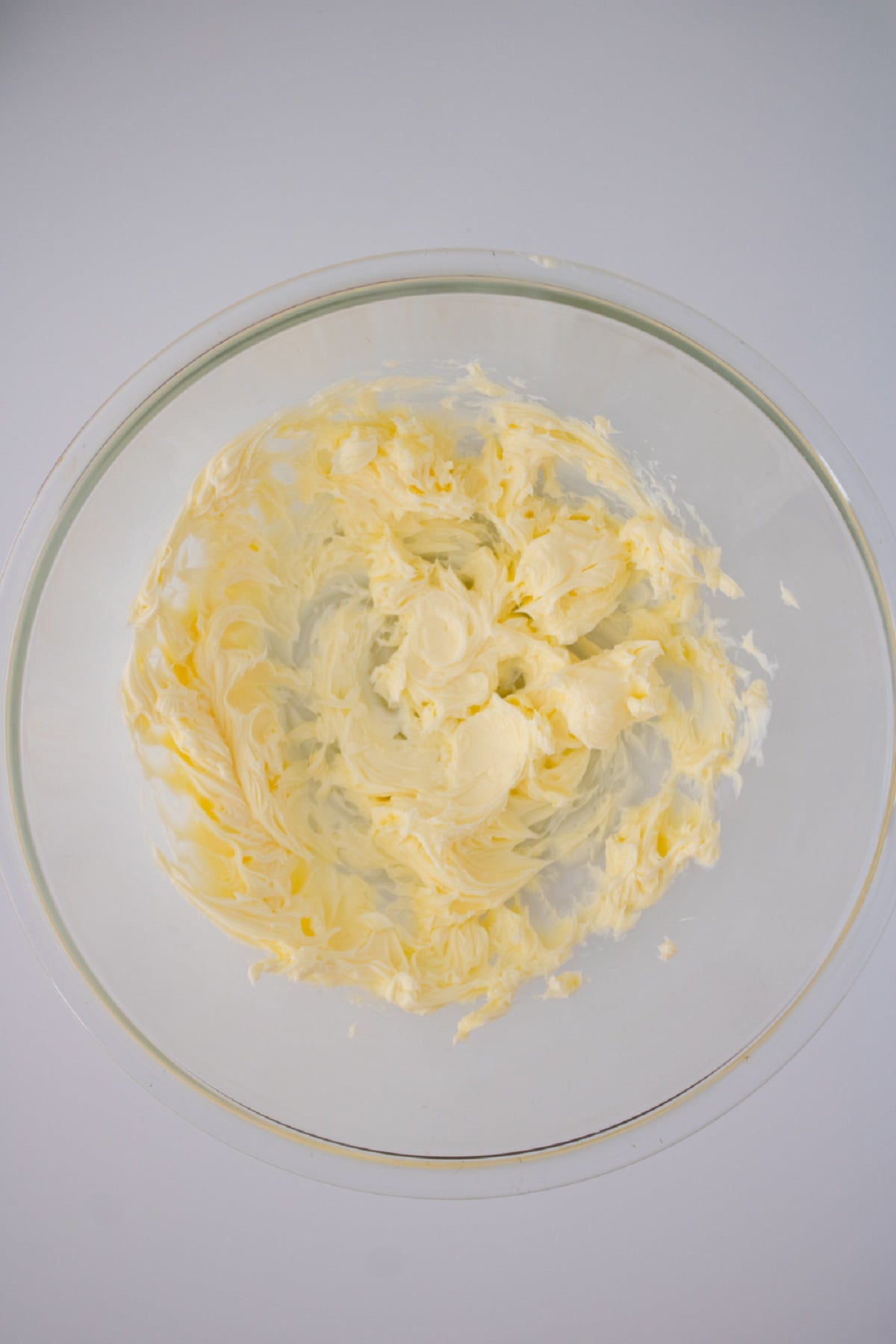 Whip butter in a bowl until fluffy.