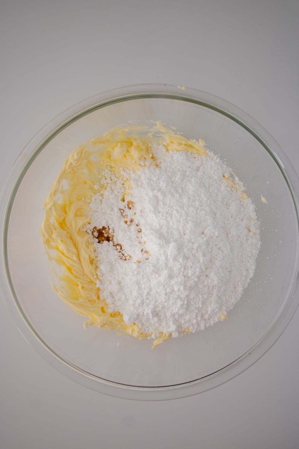 Whip powdered sugar and vanilla into the whipped butter.