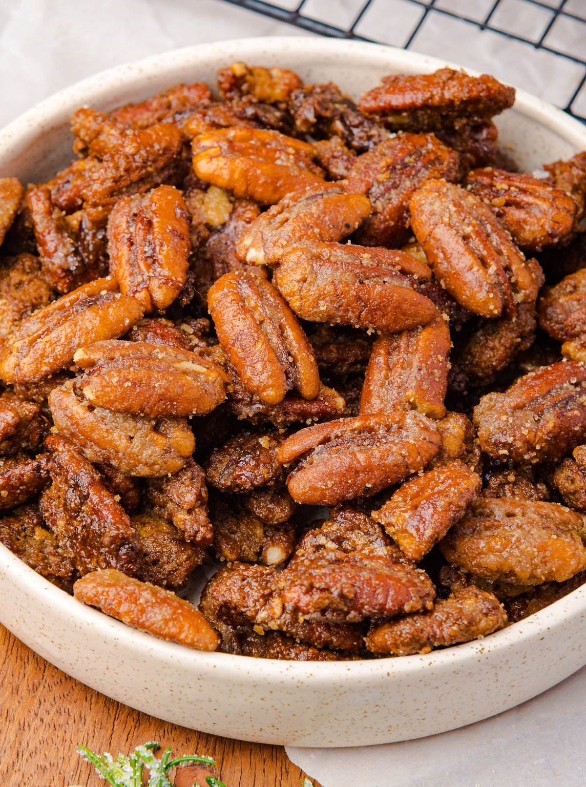 A large bowl full of candy coated pecans.