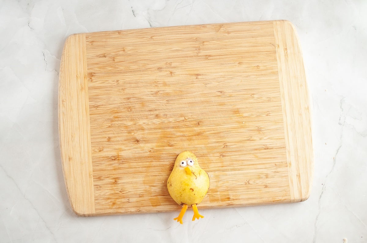 The pear and cheese are combined to make the body of the turkey.