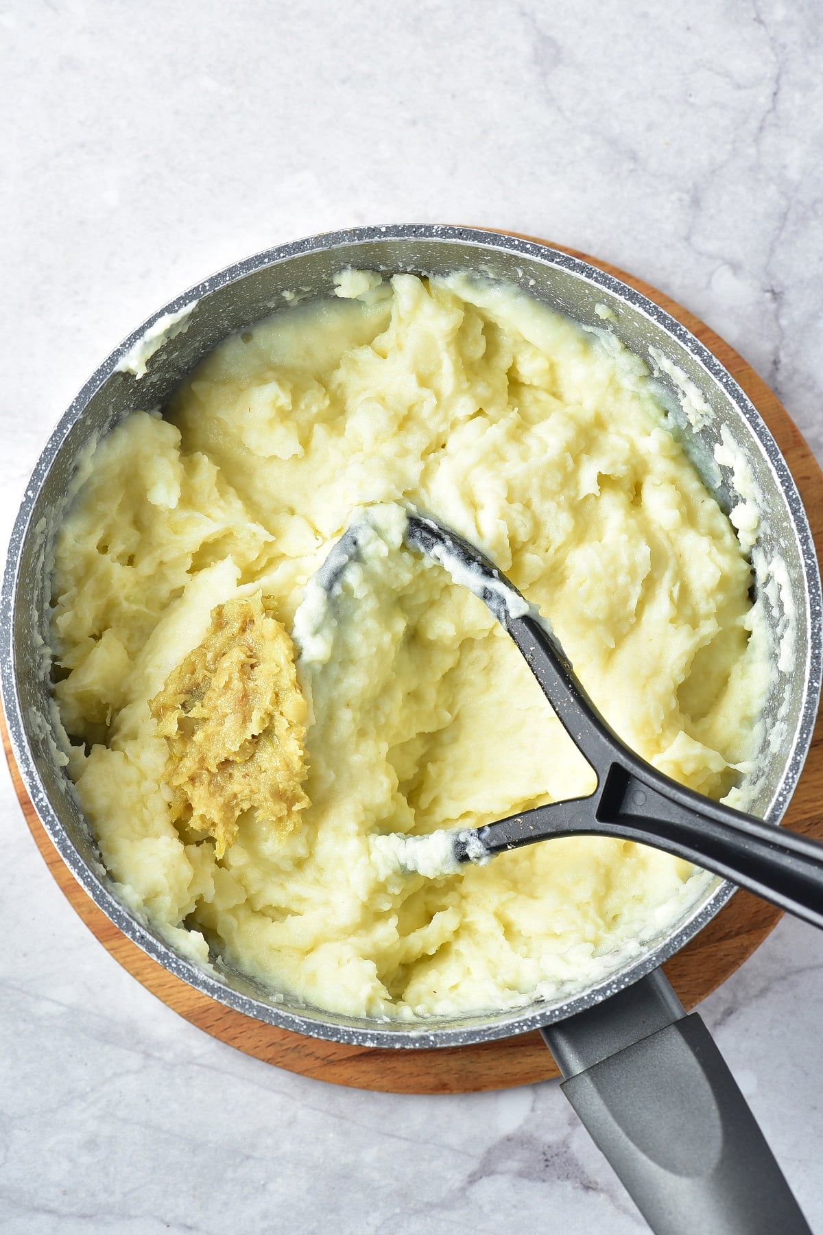 Roasted garlic is stirred into mashed potatoes. 