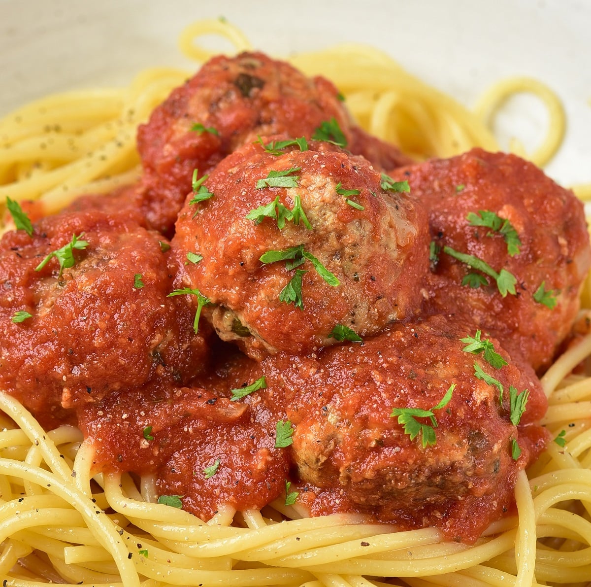 Spaghetti topped with meatballs and marinara.