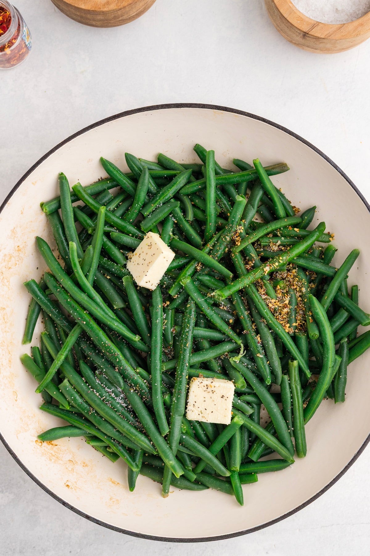 Butter and seasonings are added to sauteed green beans. 