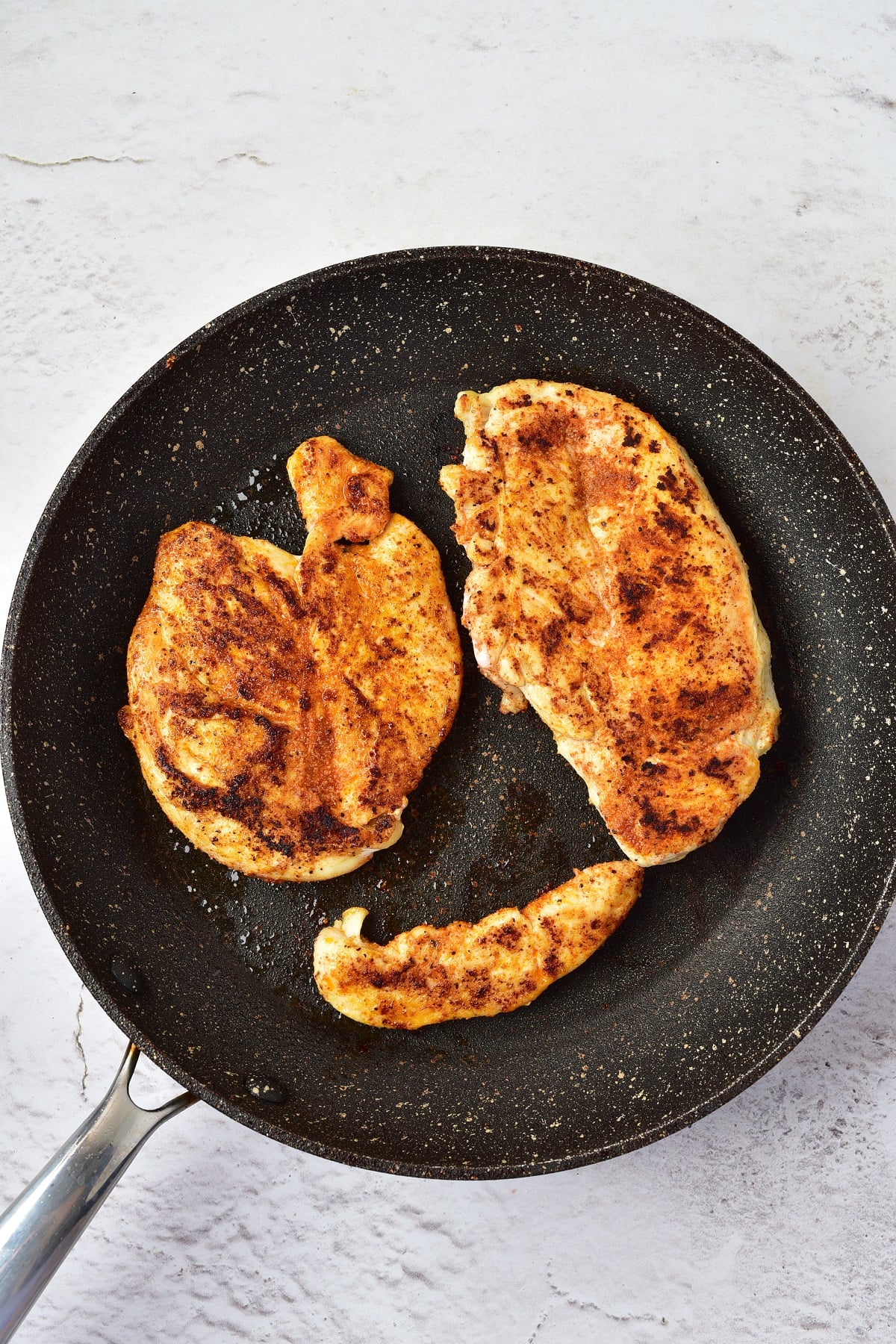 Chicken grilled in a pan.