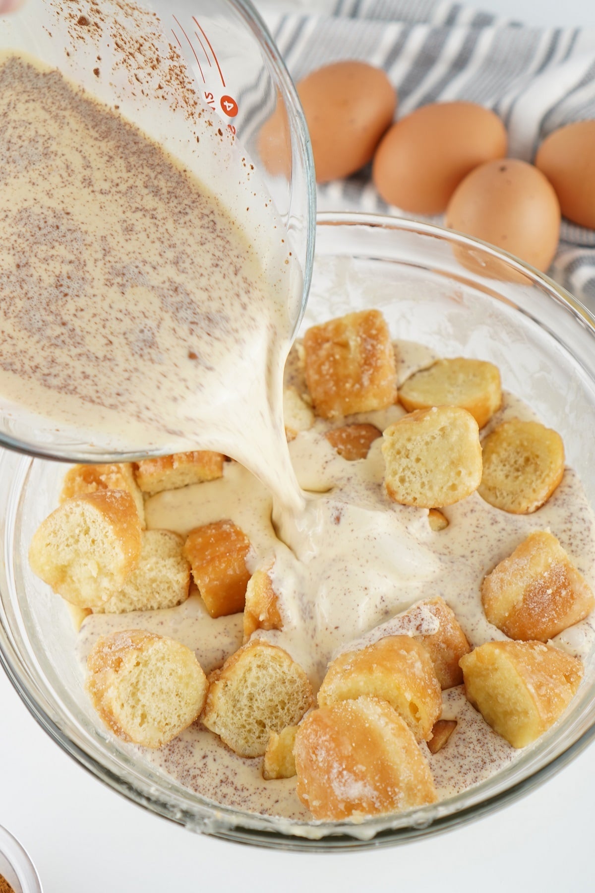 An egg custard mixture is combined with donuts. 