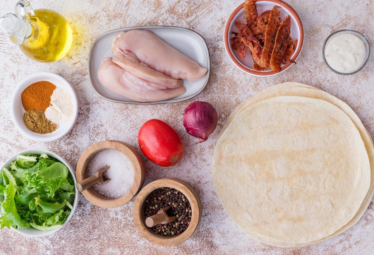 Ingredients needed to make grilled chicken wraps.