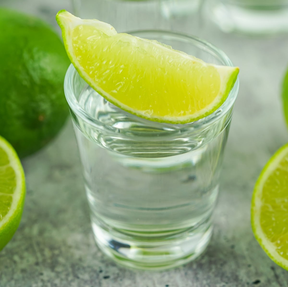 A Kamikaze shot in a glass topped with a lime wedge. 