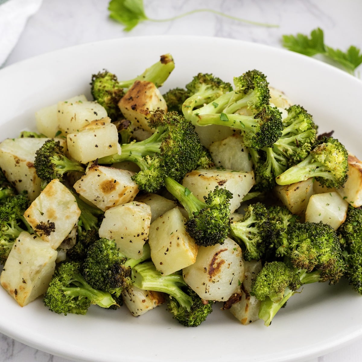 Roasted potatoes and broccoli on a plate. 