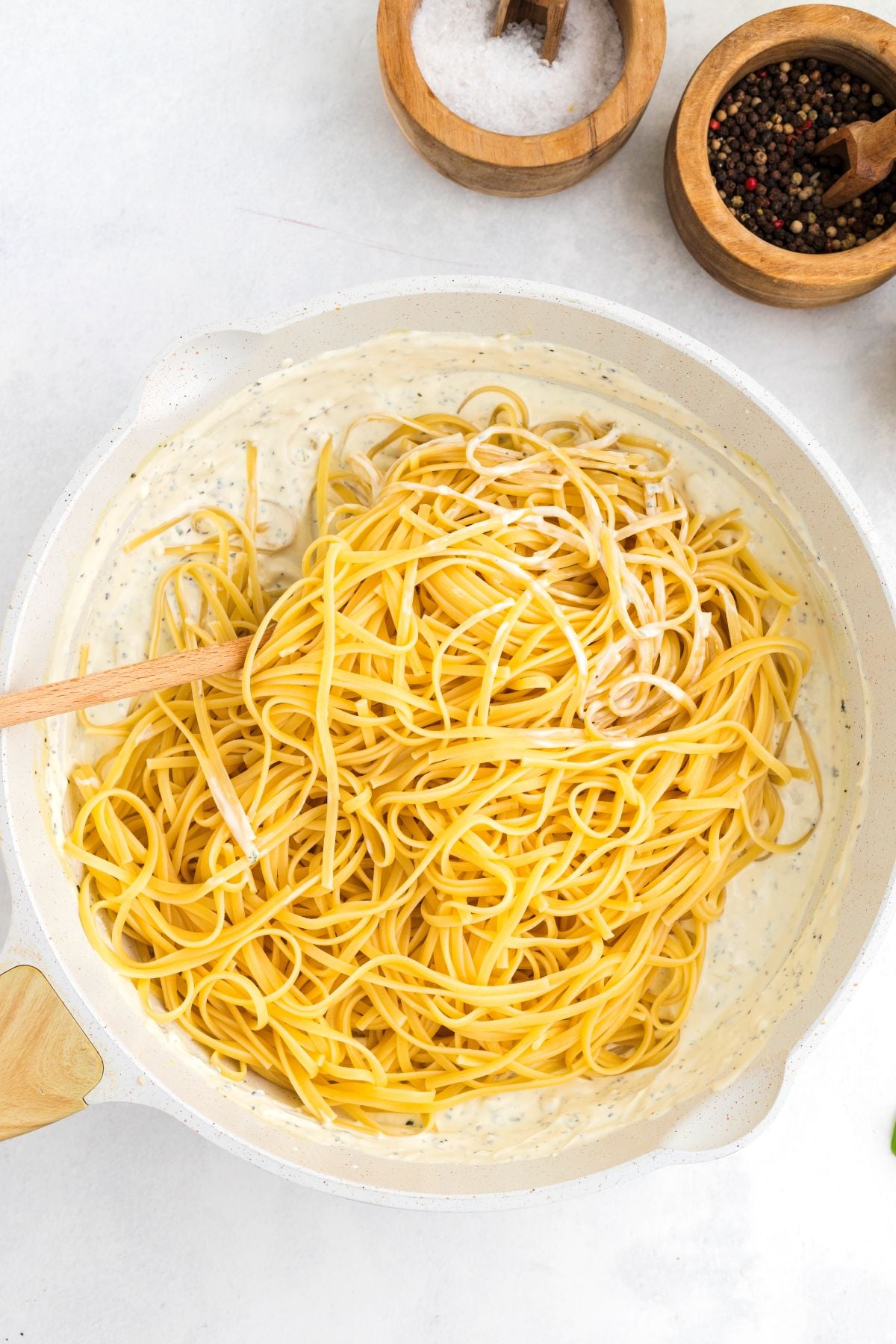 Pasta noodles are tossed with Boursin sauce. 