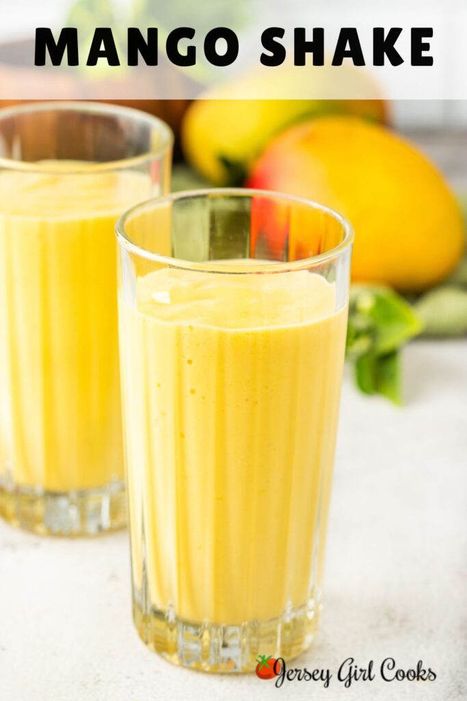 A tall glass of a mango shake with text overlay for pinterest.