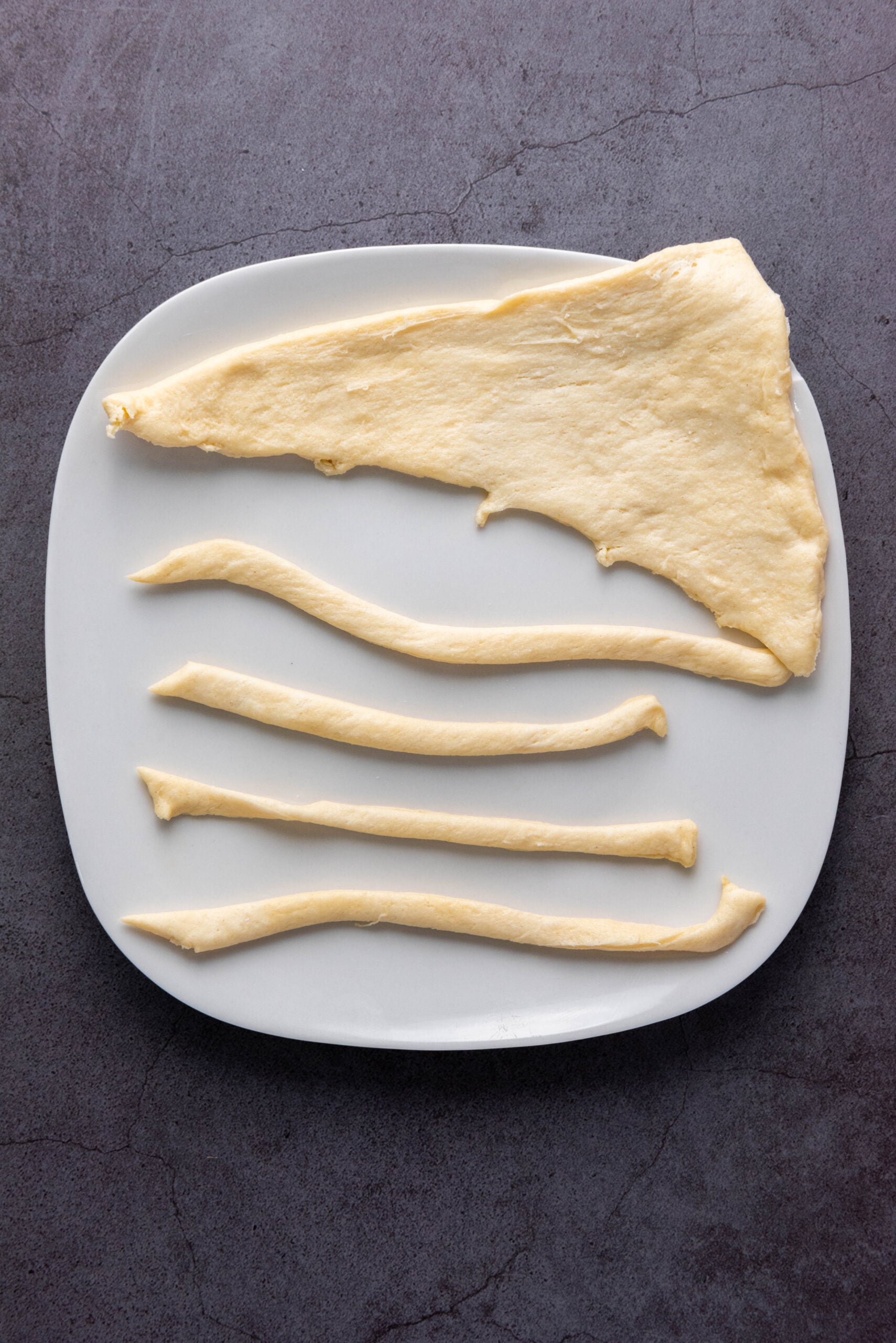 Crescent rolls are sliced into thin strips.